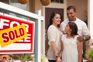 Hispanic Family in Front of Sold Home