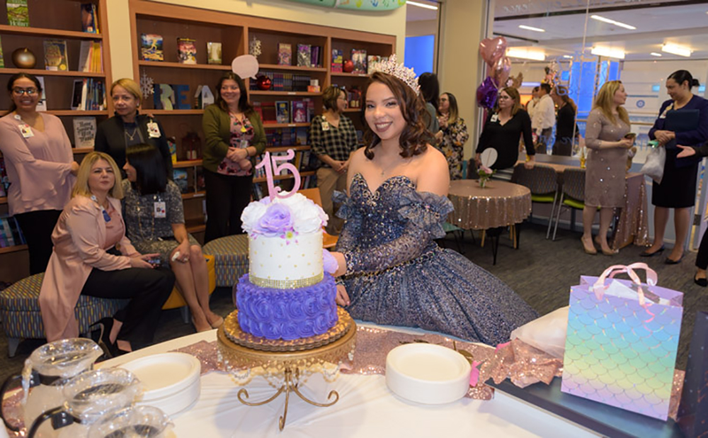 Quinceanera-Jennifer-Torres-cuts-cake-at-surprise-quinceanera-party-at-CHOC-with-Quinceanera-dot-com