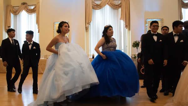Quinceaneras and chambelanes dancing in the last year event