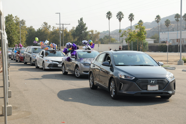 Family members cheering from their cars