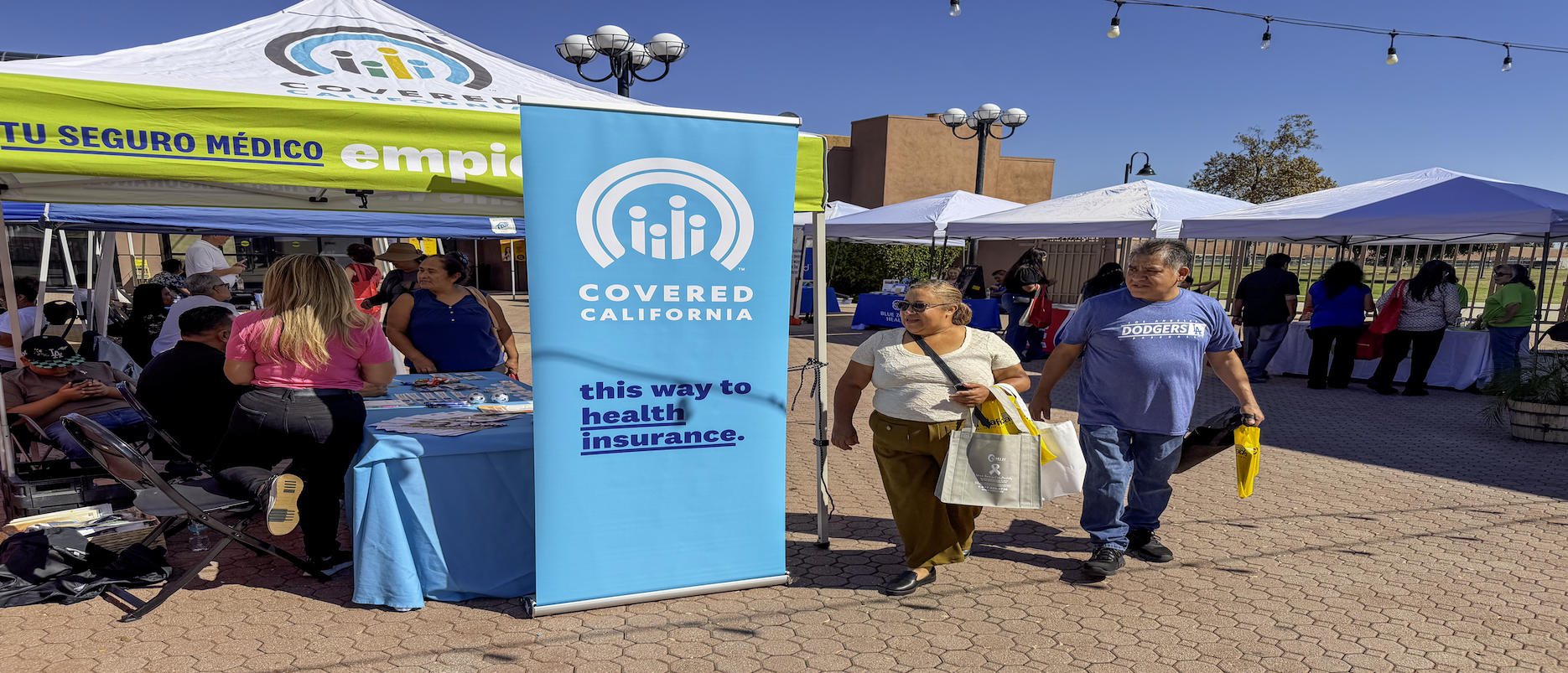 Health fair in Norwalk featuring multiple community vendors providing medical information, Medi-Cal resources, and wellness education for Latino families.